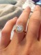 Customer photo: Chamomile Micropave Halo for cushions in 14kt yellow gold, ring size 4.75, set with a 7mm Very Light Blue H&A cushion cut Amora Gem Ultra.
