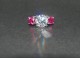 Timeless Trillium Ring in platinum, ring size 4.25.  Center stone is a 9.28mm E/VVS Amora Gem and the side stones are 5.5mm round diamond cut Avarra lab-grown rubies.