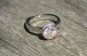 Customer-submitted image : Palladium with rose gold, 7.5mm Amora enhanced Moissanite, ring size 6.5