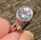 Customer-submitted image : Palladium with rose gold, 7.5mm Amora enhanced Moissanite, ring size 6.5